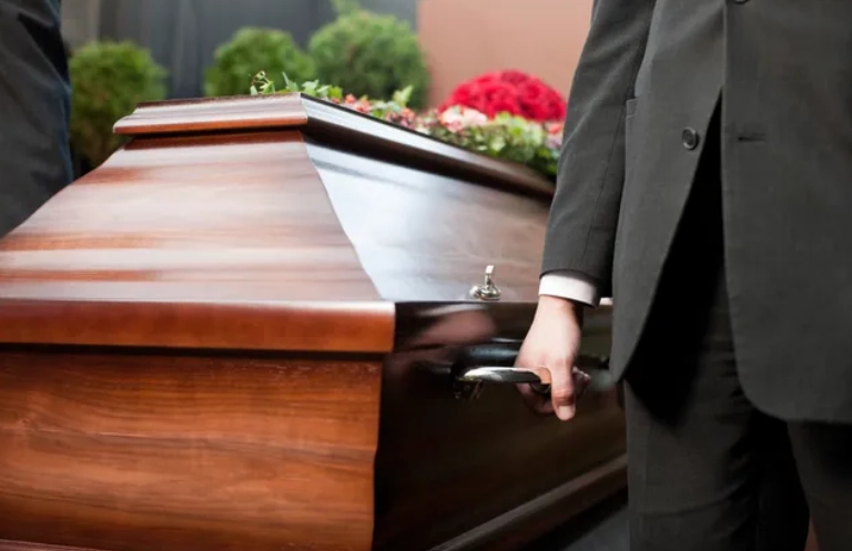 Funeral With Casket Carried by Coffin Bearer